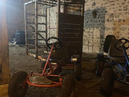 a cart with large wheels parked in a room at Domaine la Boulinière - Le Faisan in Journet