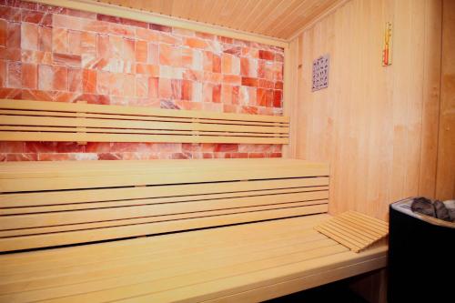 a wooden sauna with a brick wall at Turističko naselje Natura Art-Hotel Opal Art in Lohovo
