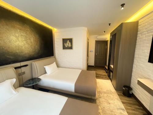 a hotel room with two beds and a television at HL 309 Hotel in Tashkent