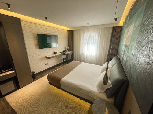 a hotel room with a bed and a television at HL 309 Hotel in Tashkent