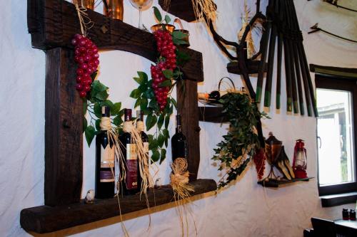 a mirror hanging on a wall with bottles and plants at Turističko naselje Natura Art-Hotel Opal Art in Lohovo