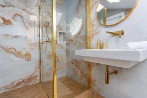a bathroom with a sink and a shower at Villa Palma Krk Penthouse apartment with sea view and private jacuzzi in Krk