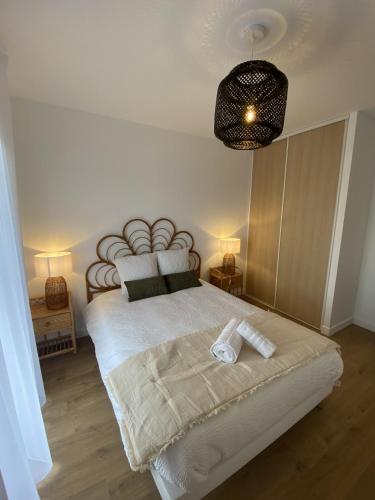 a bedroom with a large white bed with a large headboard at Montana Dijon in Dijon