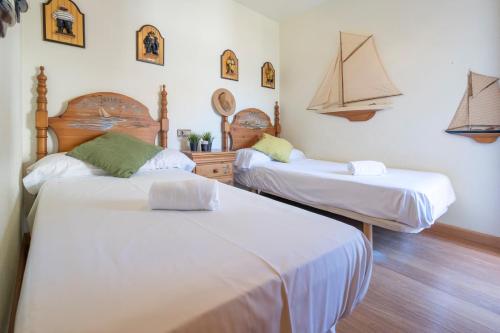 a room with two beds and a boat on the wall at 6Pax Rustic Peace Parking Varadero Beach Santa Pola in Santa Pola