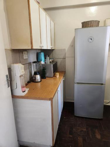 a kitchen with a white refrigerator and a counter at Beautiful View House in Vosburg