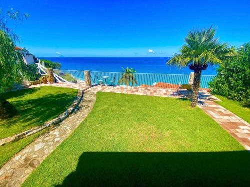 a garden with a view of the ocean at Villa Taurus Costa dei Monaci Parghelia Tropea in Parghelia