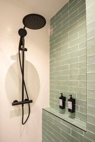 a bathroom with a shower with green subway tiles at Puerto Canalejas 1 in Santander