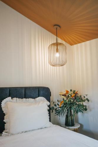 a bedroom with a bed and a vase of flowers at Casa da Veiga de Ponte de Lima in Ponte de Lima
