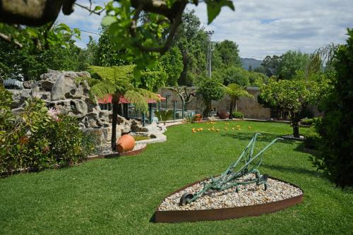 a garden with a statue in the grass at Casa da Veiga de Ponte de Lima in Ponte de Lima