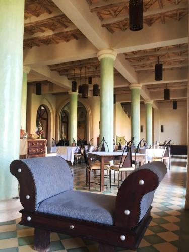 a couch in a room with tables and chairs at Kasbah Titrit & Spa in Aït Ben Haddou