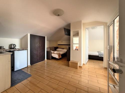a room with a kitchen and a room with two beds at Arhontisa Studios by SDR in Paralia Katerinis