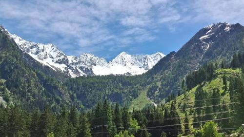 a view of a mountain range with snow at Dimora Alpina in Vermiglio