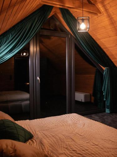 a bedroom with a bed and a large window at Hygge Sauna&Spa in Gleźnowo