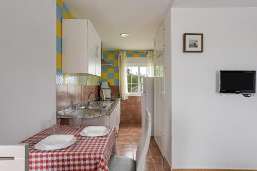 Televízia a/alebo spoločenská miestnosť v ubytovaní Apartamento Villa Mayo C