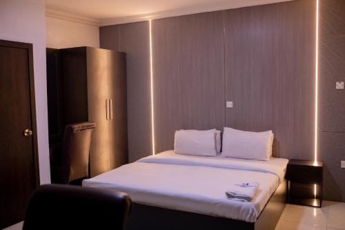 A bed or beds in a room at Skyrock Hotels Ogba
