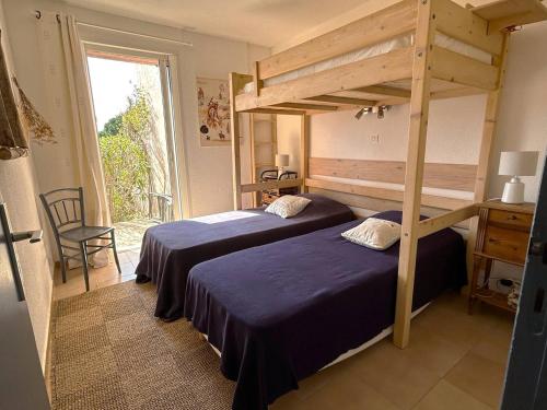une chambre avec deux lits et une grande fenêtre dans l'établissement Mini-villa à 5 minutes de la plage de Santa Giulia, à Porto-Vecchio