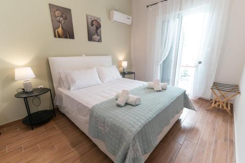 a bedroom with a bed with two towels on it at Skyard - Central 2bd House in Kos