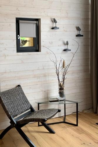 a room with a mirror and a chair and a table at Le Clos 1855 in Saint-Laurent-des-Bâtons