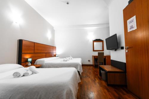 Postel nebo postele na pokoji v ubytování Hotel City Center