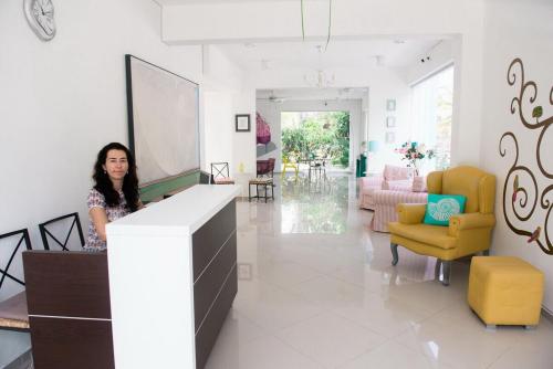 a woman standing at a counter in a living room at Art Villa Dominicana in Punta Cana