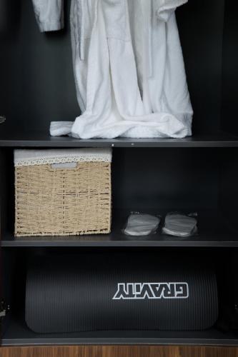 a black shelf with towels and towels on it at Pana Unique Kolsay in Kurmenty