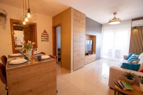 a kitchen and living room with a couch and a table at Relax Mandre 200m from the beach Sea view in Mandre