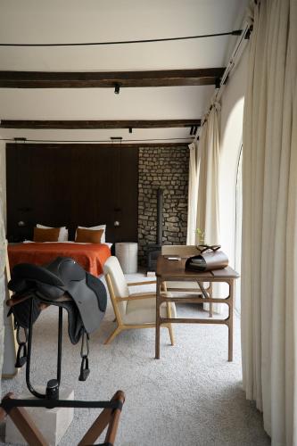 a bedroom with a bed and a table with a chair at Pana Unique Kolsay in Kurmenty