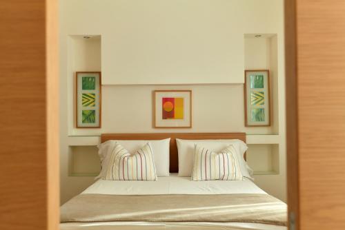 a bedroom with a bed with two pillows at Hotel Saraceno Resort with Private Beach in Milano Marittima