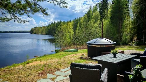 a picnic table with a view of a lake at Nature Dream Days in Muhos