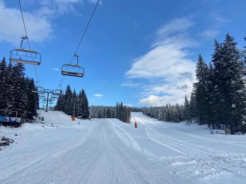 a snow covered ski slope with a ski lift at Woodside Kopaonik 417-418 in Kopaonik