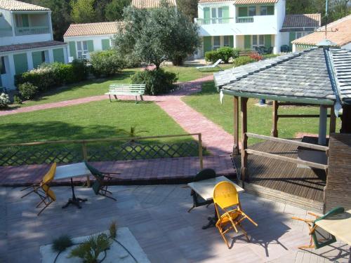 a patio with chairs and a gazebo at Le Parasol in Ars-en-Ré