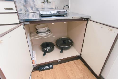 a small kitchen with a sink and dishes in it at 6 minutes walk from Ichikawa Station Single-family house with 3 bedrooms and 1 living room Rich living facilities around in Ichikawa