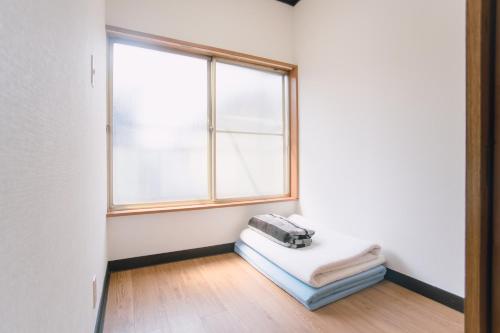 an empty room with a window and a mattress at 6 minutes walk from Ichikawa Station Single-family house with 3 bedrooms and 1 living room Rich living facilities around in Ichikawa