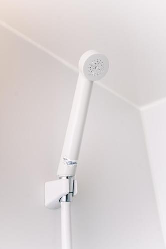 a white pole with a fan on a white background at 6 minutes walk from Ichikawa Station Single-family house with 3 bedrooms and 1 living room Rich living facilities around in Ichikawa