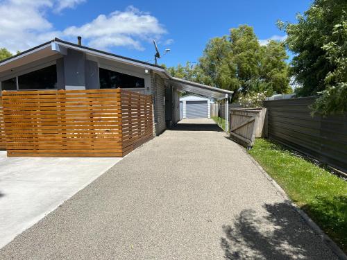 a driveway leading to a house with a garage at Palmy Hideaway - Dog Friendly in Palmerston North