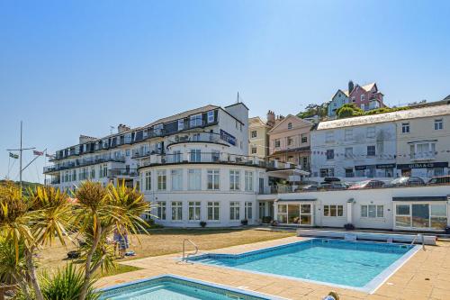 a large white building with a swimming pool in front of it at No 16 The Salcombe in Salcombe