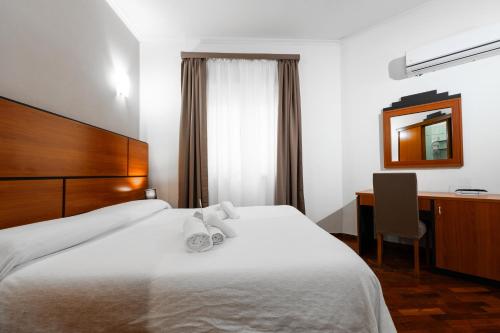 Postel nebo postele na pokoji v ubytování Hotel City Center