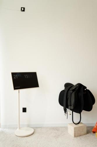 a clock on a stand next to a bag at Pana Unique Kolsay in Kurmenty