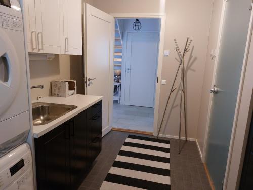 a small kitchen with a sink and a microwave at Kuukkeli in Kalajoki