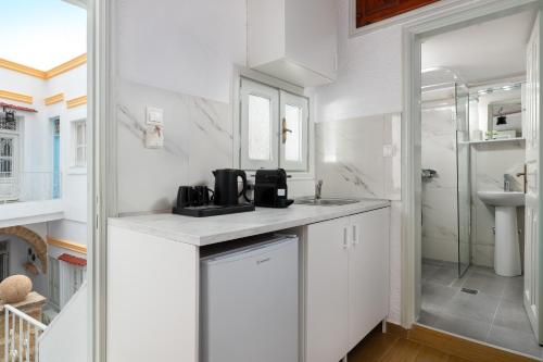 a white kitchen with a sink and a shower at Casa Tradizionale in Rhodes Town