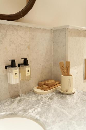 a bathroom with a counter with a toilet in it at Pana Unique Kolsay in Kurmenty