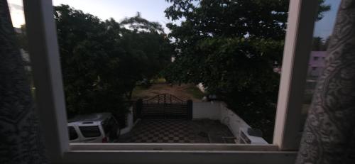 a view of a yard from a window at SHI's Kurunji 5BHK Villa in Pollachi in Pollāchi