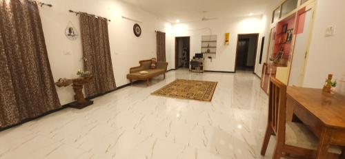 a living room with a couch and a table at SHI's Kurunji 5BHK Villa in Pollachi in Pollāchi