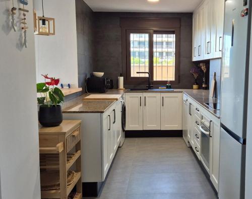 a large kitchen with white cabinets and a sink at Blue Amber-Los Arenales del Sol-Alicante in Arenales del Sol