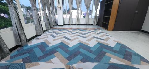 a hallway with a colorful rug on the floor at SHI's Kurunji 5BHK Villa in Pollachi in Pollāchi