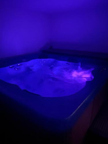 a dark room with a hot tub with purple lights at Vila Malenovice in Malenovice