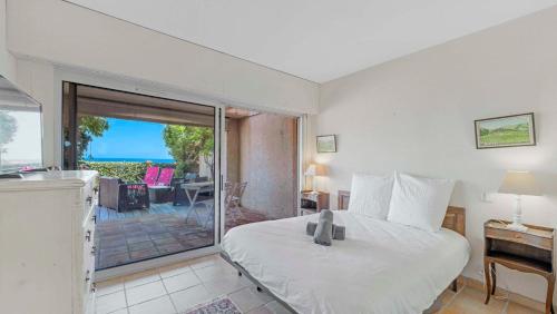 a bedroom with a bed and a sliding glass door at CASA SELLA Beautiful terrace with Sea View in Sainte-Maxime
