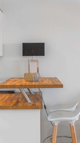 a wooden table with two white chairs next to a desk at CASA SELLA Beautiful terrace with Sea View in Sainte-Maxime