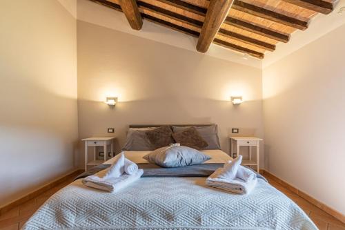 a bedroom with a bed with two pillows on it at Masseria del bosco Poderuccio in Chianciano Terme