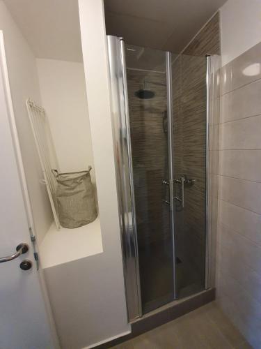a shower with a glass door in a bathroom at Slatki kut in Vis